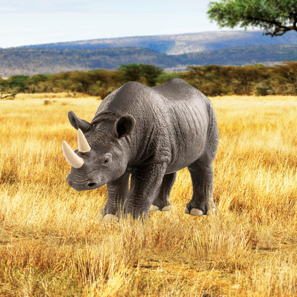 Toy rhino figurine in savannah