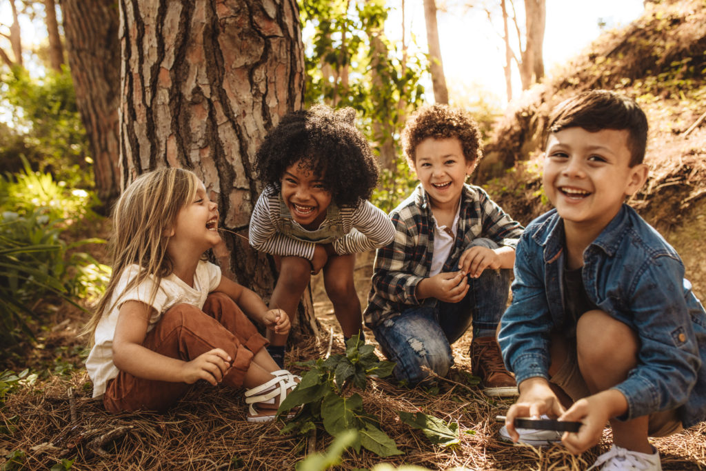 Children learning and playing outside in a forest school